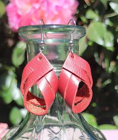 These charming deep red leather twist earrings are 1-1/2  inch long.  That is the length of the leather. Please see photos for the overall length.  They are the perfect size to enhance your outfit without being to bold. They are lightweight, you will forget that you are wearing them. I would suggest keeping them out of water. Leather tends to get spotted and can shrink.  They are suited for sensitive ears.  **USUALLY SHIPS NEXT DAY  *Nickle free hooks  PLEASE SEE PHOTOS FOR TOTAL LENGTH. GET COMPLIMENTS 😎 They look good with casual clothes, work clothes or a night out on the town with jeans and a shirt. They are subtle beauties. I'm sure you will get plenty of compliments! They also make great  gifts for someone special like your Bestie, Mom, daughter Aunt co-worker. You get the picture. Adjustable Red Leather Earrings, Red Leather Earrings For Gifts, Red Leather Earrings, Twist Earrings, Casual Clothes, Mom Daughter, Work Clothes, Sensitive Ears, Deep Red