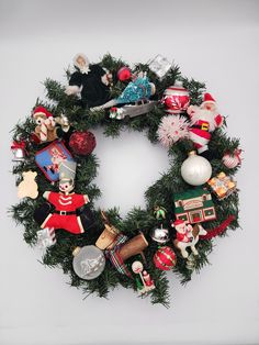 a christmas wreath with ornaments hanging from it