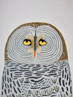 an owl with yellow eyes sitting on top of a table