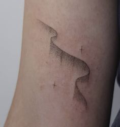 a woman's arm with a small tattoo on the left side of her body