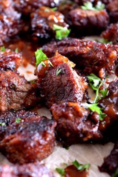 closeup of meat with sauce and parsley on the top, ready to be eaten