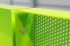 a close up view of the side of a green metal cabinet with holes and rivets