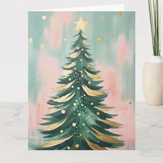 a card with a painting of a christmas tree on the front and gold stars on the back