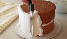 someone is cutting into a cake with a knife