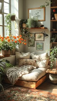 a living room filled with lots of potted plants next to a couch covered in pillows