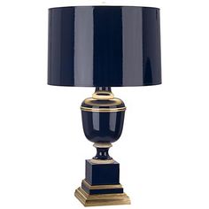 a black and gold lamp on a white background