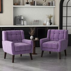 two purple chairs sitting next to each other in front of a counter top and shelves