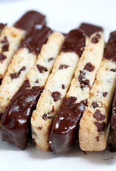 chocolate covered cookies are arranged on a white plate