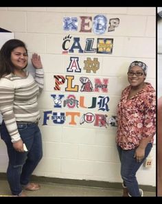 two women standing next to each other in front of a whiteboard with letters on it