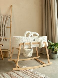 a white wicker basket sitting on top of a wooden rocking chair