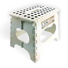 a white step stool with holes on it