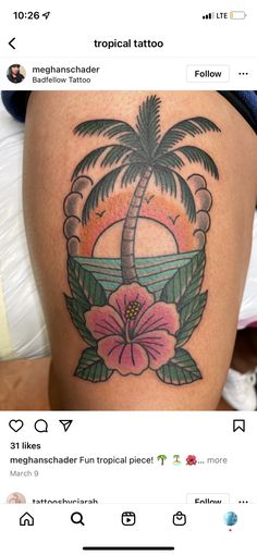 a woman's thigh with a palm tree and flowers on it