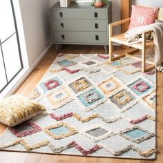 a living room with a chair and rug on the floor