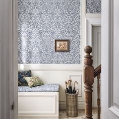 an entry way with blue and white wallpaper