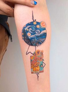 a person with a tattoo on their arm holding up a piece of art that looks like the starry night sky