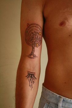 a man with a tree tattoo on his arm