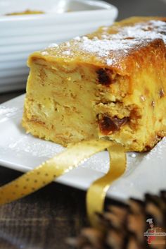 a piece of cake sitting on top of a white plate next to a yellow ribbon