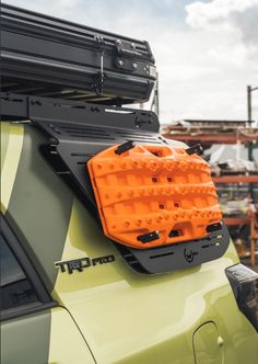 an orange case on the back of a green vehicle