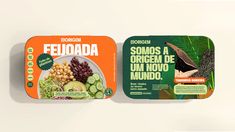 two tins of food with different types of vegetables and fruits in them on a white surface