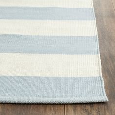 a blue and white striped rug on the floor