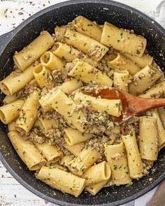 a skillet filled with pasta and meat sauce