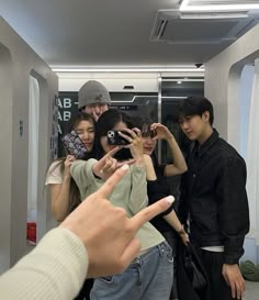 a group of people standing around each other taking pictures