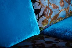 a blue couch with gold and black designs on it