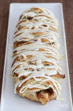 a white plate topped with a pastry covered in icing