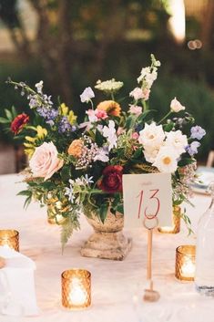 a table with flowers and candles on it