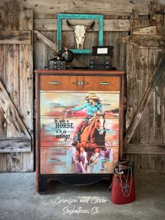 an old dresser has a painting on it