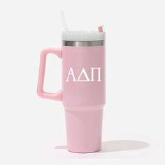 a pink travel mug with the word aati on it and a straw sticking out