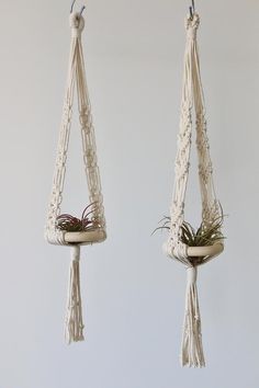 two macrame hanging planters with plants in them