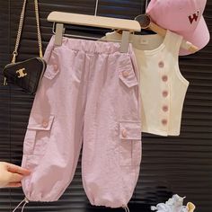 Product ID: BB51458  Material: 90% Cotton  Color: Apricot, Pink      Size Chart        Size (Age)     Height (CM)     Chest (CM)     Waist (CM)       18-24M  86-95  50  40     2-3T  95-105  53  42     3-5T  105-115  56  44     5-7T  115-125  59  46     7-9T  125-135  62  48     9-11T  135-145  65  50      *It's recommended to choose the size that corresponds to your mini's height and body measurements for a much more accurate fit. Please also take delivery time into consideration.  *The parcel only contains the tank top or pants. Other pieces or accessories shown are only used for photo props. Cute Pink Pants With Pockets, Playful Pink Bottoms With Pockets, Cute Summer Pants With Pockets, Pink Cotton Pants For Playwear, Pink Cotton Playwear Pants, Pink Summer Playwear Pants, Playful Spring Pants With Pockets, Playful Spring Pants, Cute Summer Playwear Pants