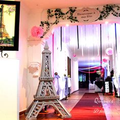 the eiffel tower is decorated with pink flowers and greenery for an event