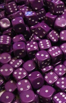 purple dices with white dots are stacked on top of each other for sale in a store