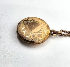 Gold filled etched locket mid century photo necklace. Good used condition with little to no signs of normal wear. Chain has early thumb clasp. Etched with the number 16 on the inside of each side of locket. Comes with vintage picture and frame. Necklace measures 15.5 inches long. Locket measures 5/8ths of an inch across. Vintage Etched Locket Necklace For Keepsake, Vintage Etched Jewelry For Keepsake, Vintage Etched Jewelry Keepsake, Antique Medallion Locket Necklace, Vintage Medallion Locket Jewelry, Costume Jewelry Medallion Locket Necklace, Vintage Filigree Medallion Locket Necklace, Vintage Etched Necklaces For Keepsake, Vintage Style Etched Necklace For Keepsake