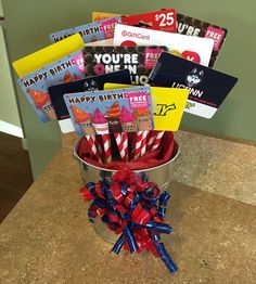 a bucket filled with lots of candy and greeting cards on top of a countertop