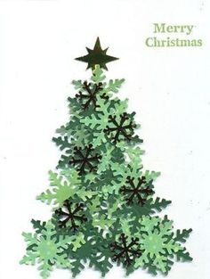 a christmas tree made out of paper with snowflakes and stars on the top