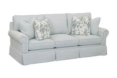 a light blue couch with three pillows on it's back and two side ends