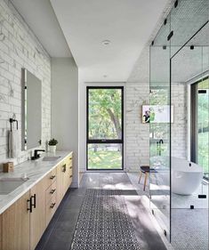 a large bathroom with two sinks and a bathtub next to a walk in shower