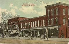 an old photo of a building in the middle of town