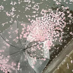 an umbrella with pink flowers floating on the water