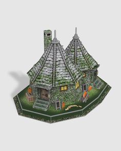 a paper model of a house made out of grass