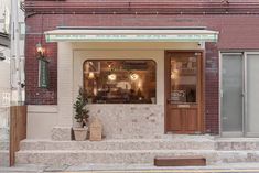 a brick building with an awning on the front and steps leading up to it