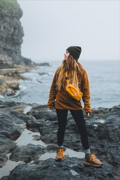 Image of a person hiking during a autumn. They are wearing a stylish outfit featuring Fjallraven gear, Columbia clothing, and Danner boots Outdoor Boots Outfit, Danner Hiking Boots Outfit, Stylish Hiking Outfit Cold Weather, Styling Hiking Boots, Columbia Boots Outfit, Womens Danner Boots Outfits, Hoka Hiking Boots Outfit, Comfy Hiking Outfit, Outfit With Hiking Boots