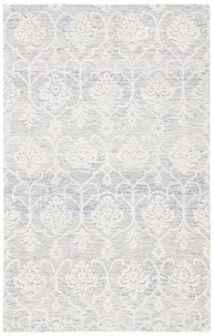 an area rug with white and blue designs on it, in front of a white background