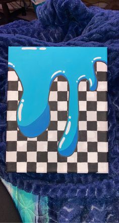 a piece of art that looks like it is dripping blue paint on a checkerboard background