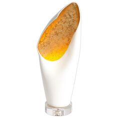 a white vase with an orange substance in it