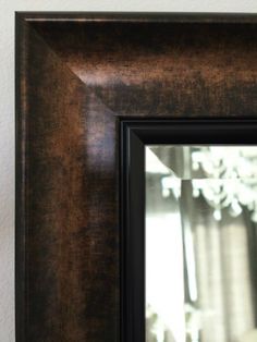 a wooden frame with a black border around the edges and an image of a vase behind it