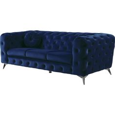 a blue velvet couch with metal legs and buttons on the back, sitting against a white background